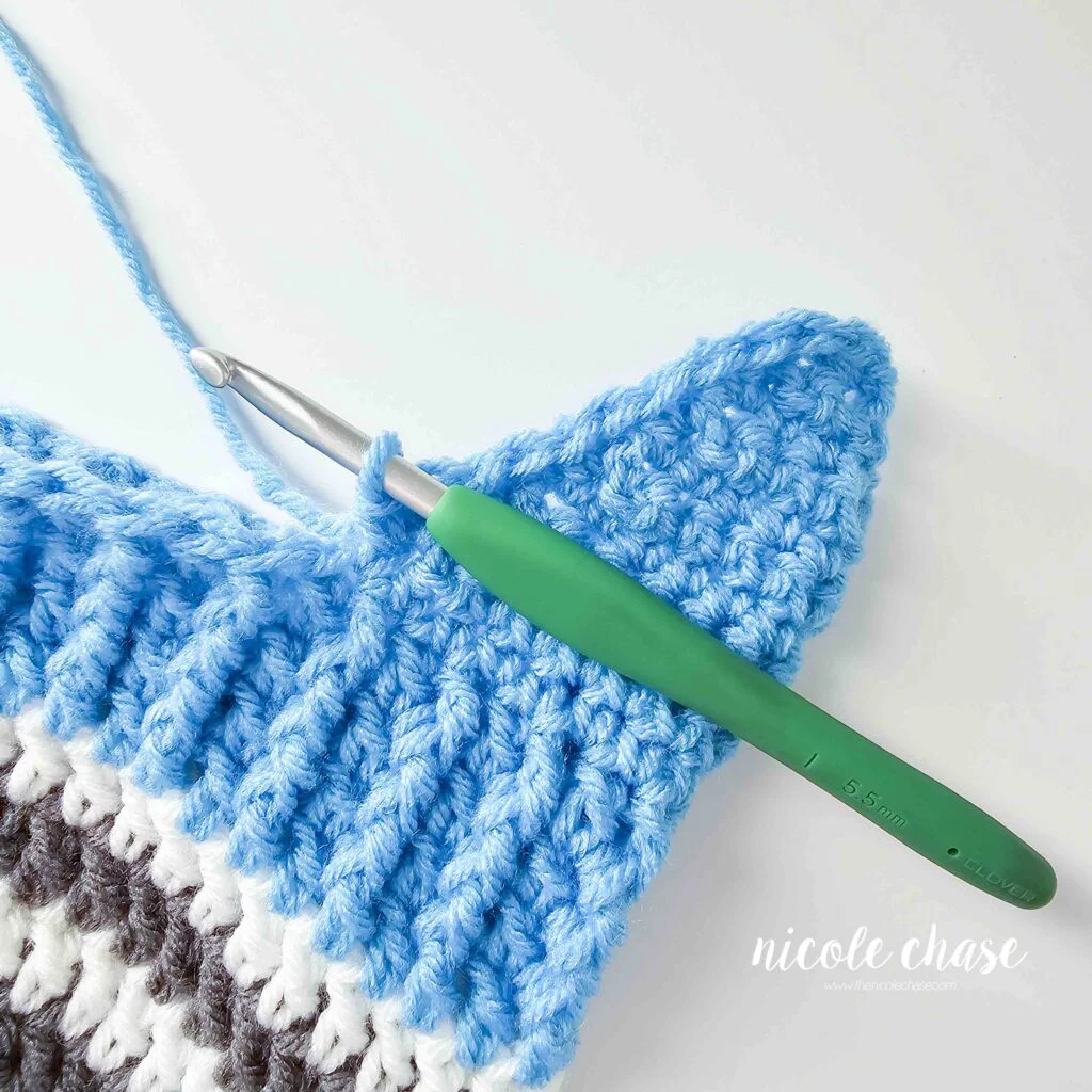 Crocheting around the edge of the earflap on the Spirit Earflap Hat crochet pattern. 