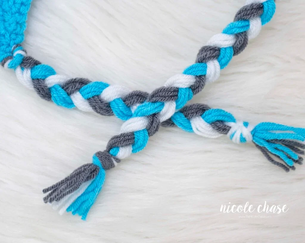 Finished braided tassels on the Spirit Earflap Beanie crochet pattern. 