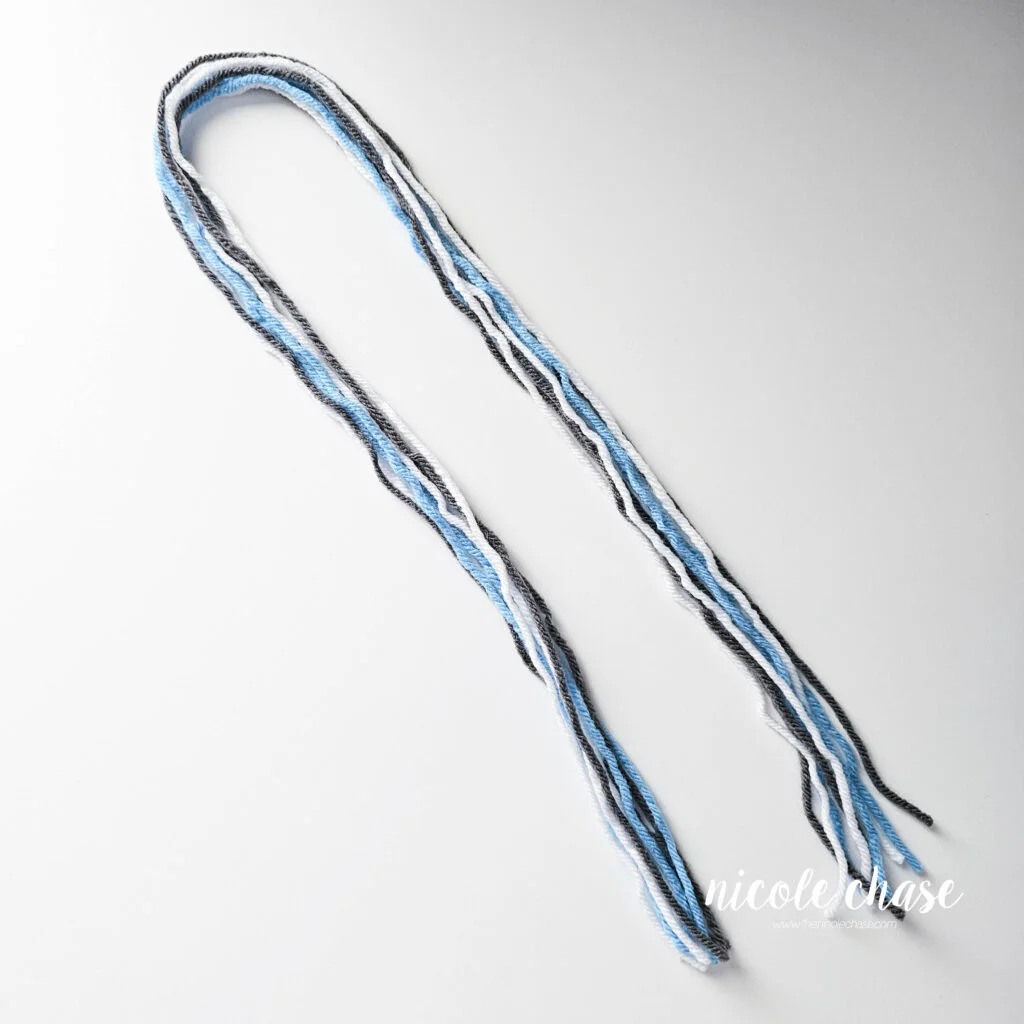 Strands of yarn to create the tassels for the earflap beanie crochet pattern. 