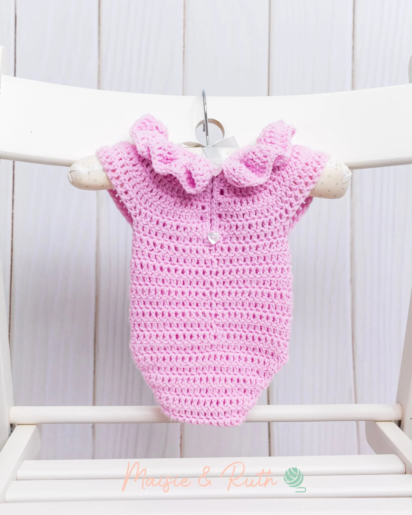 Crochet Baby Romper Back View Hanging on Chair