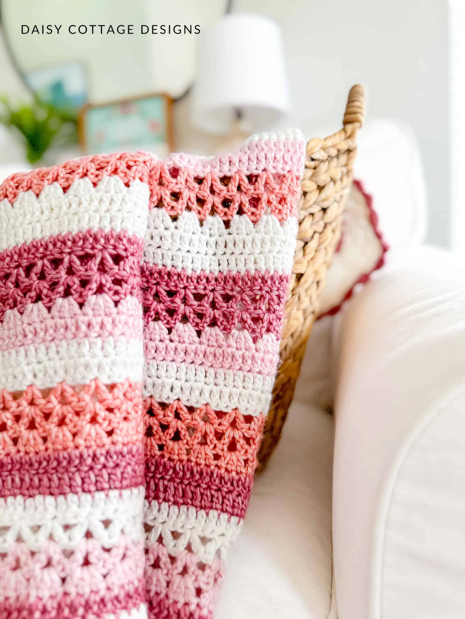 striped crochet blanket draped over a basket