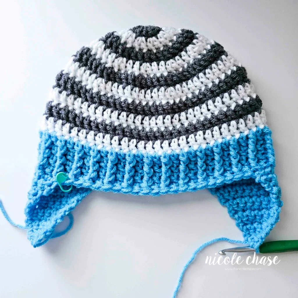 Tutorial image displaying the finished earflaps on the spirit earflap hat crochet pattern prior to weaving in the ends. 