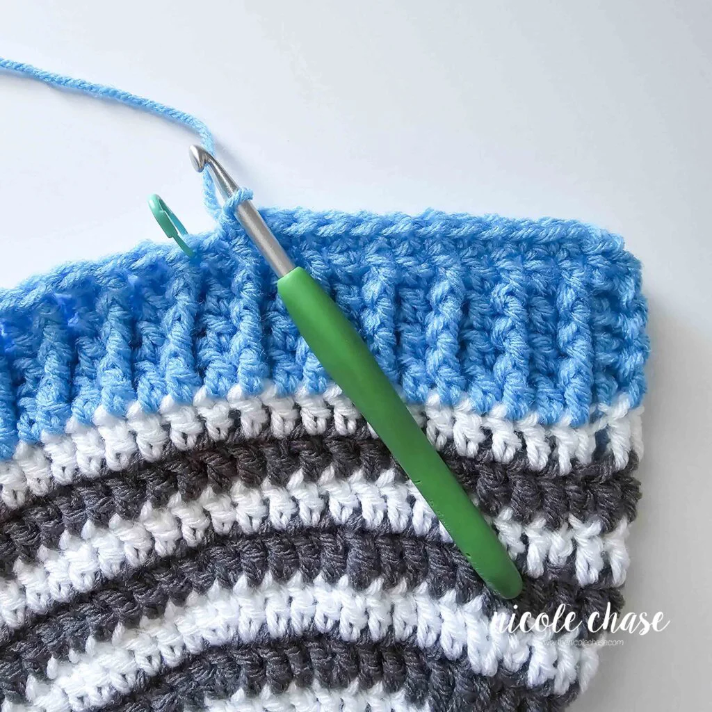 Tutorial image displaying the first row of the first earflap on the crochet earflap beanie pattern.