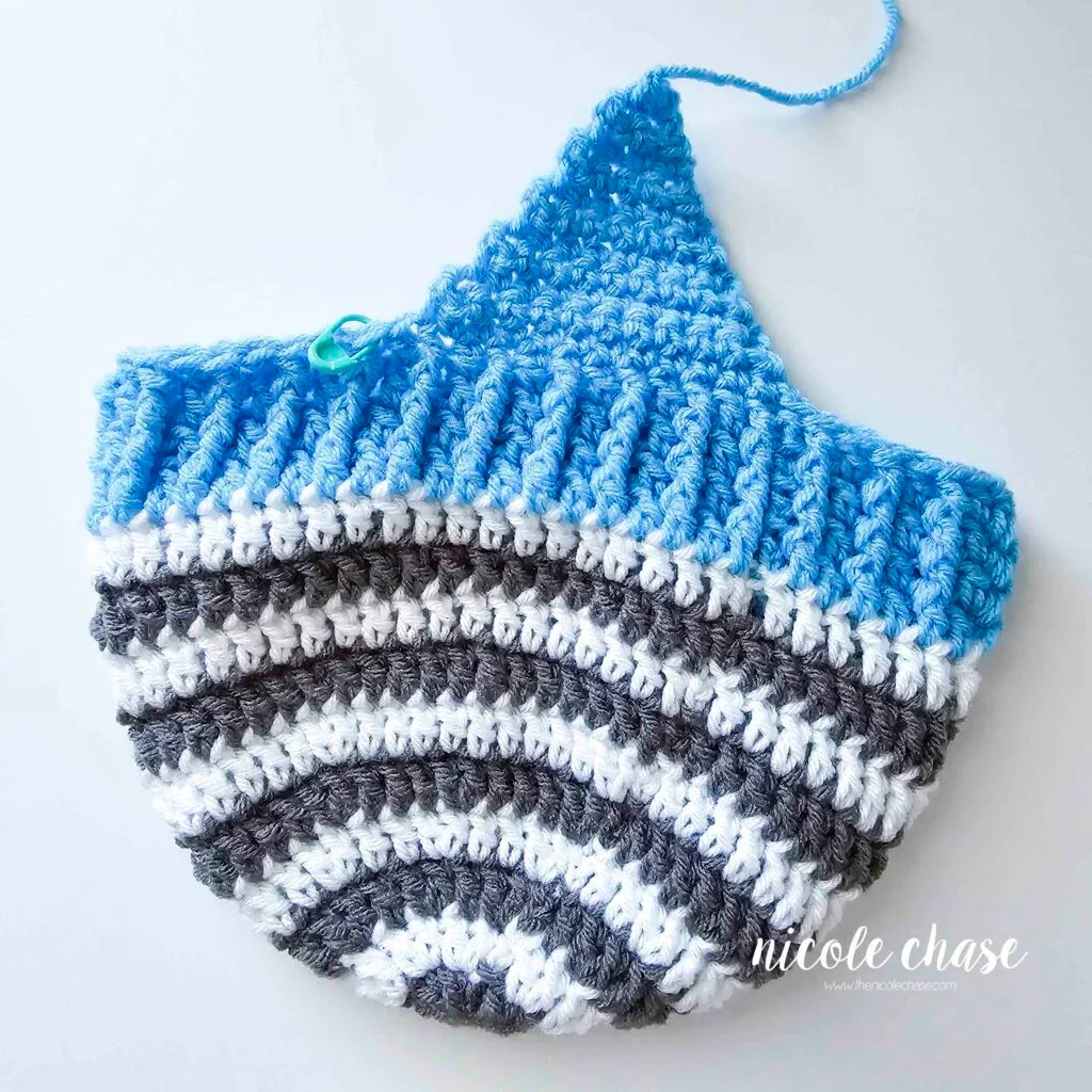 Tutorial image displaying the finished first earflap on the crochet earflap beanie pattern.